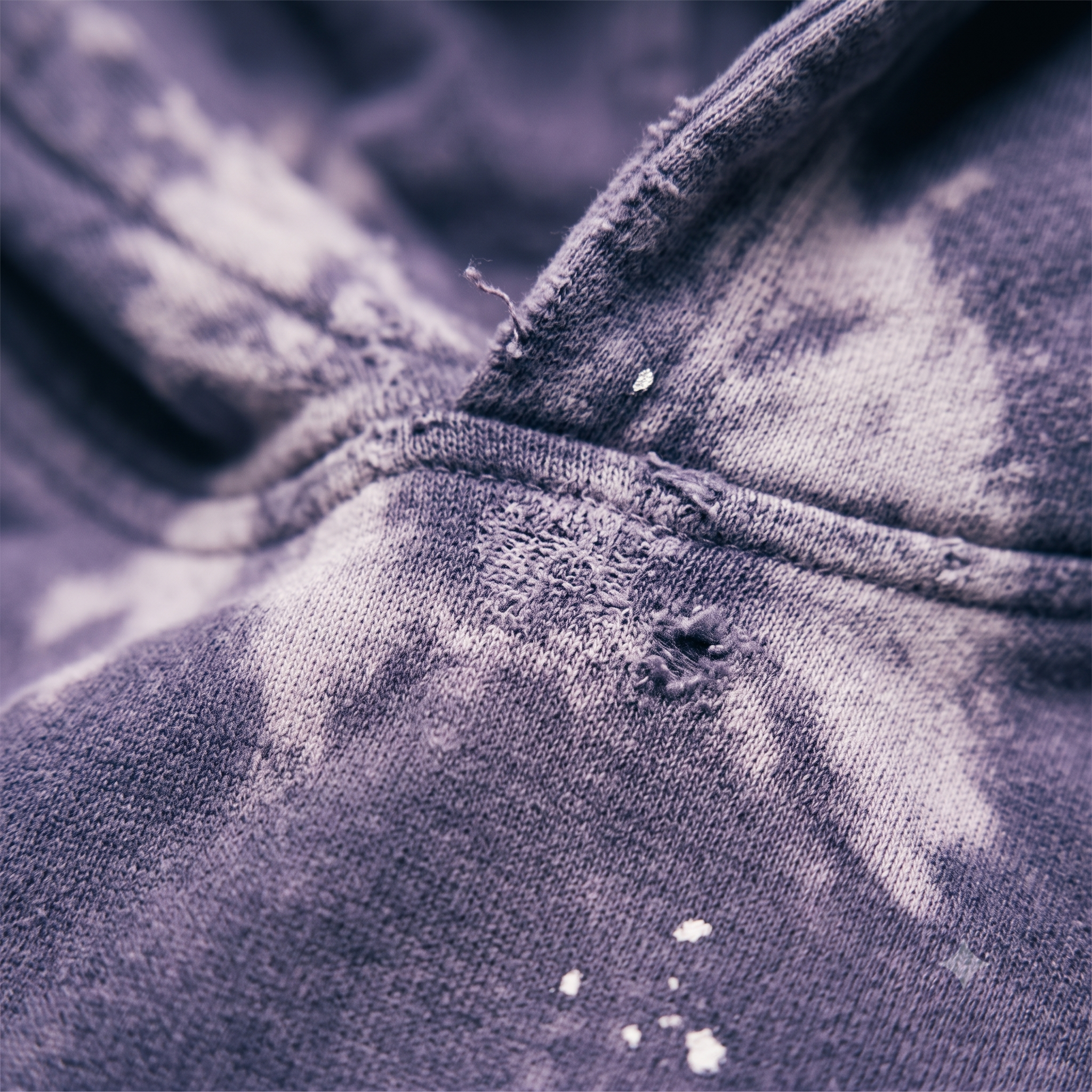 Close-up of MYVZN Drained of Soul hoodie showing frayed distressed seam and washed purple heavyweight fleece texture